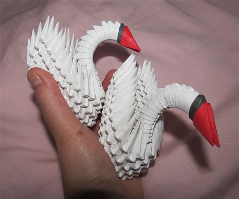 In this Arts & Crafts video tutorial you will learn how to make a 3D origami swan from 484 paper triangles. For this you will have to cut up 16 sheets of paper in to small rectangles. One rectangle is 1/32 of an A4 sheet. Take a small rectangle, fold it in half lengthwise and again fold it the other way. Open up the last fold and fold the closed …